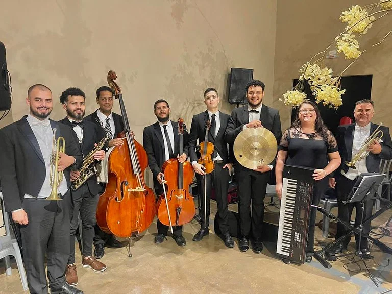 Grupo de música ao vivo com sopros e cordas em evento